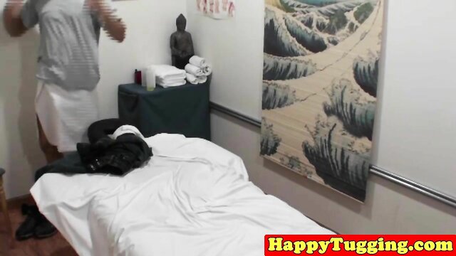 Tattooed masseuse gives happy tugjob in massage room