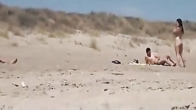 Couple\'s intimate moment interrupted by strangers on a nude beach